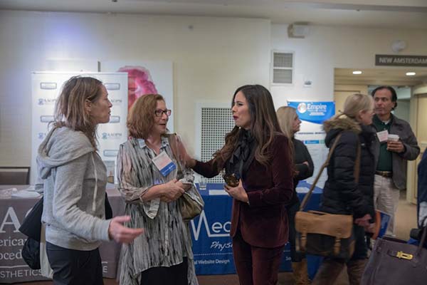 Cosmetic Laser Instructor conversing with EMT attendees