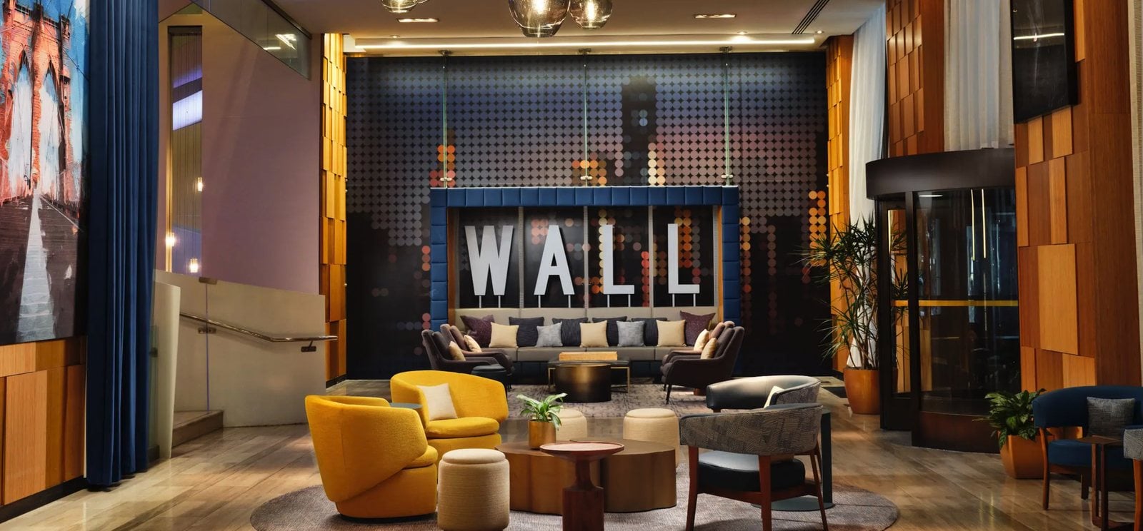 The lobby of the Hyatt Centric Wall Street, with its Wall installation and lounge seating