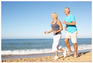 couple walking on the beach enjoying good health